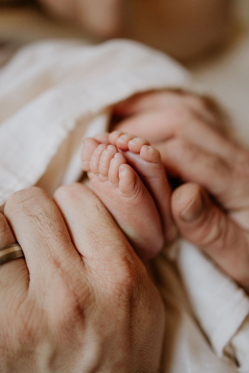 Father holding newborn in home photography session in Adelaide