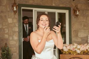 Wedding moment captured at rustic stone venue entrance with evening lighting.