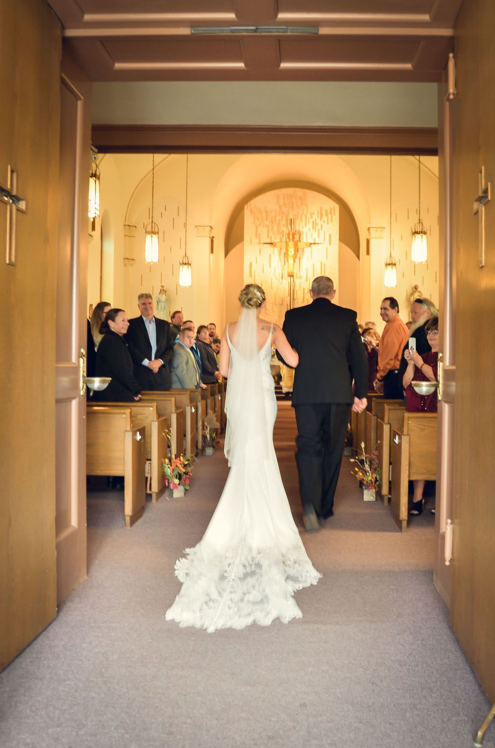 Series of progressive photos showing a bride and her escort walking down a church hallway during a wedding ceremony.