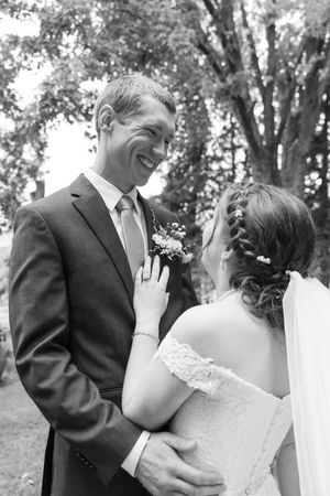 Black and white romantic wedding portrait series showing intimate moments between newlyweds in an outdoor garden setting.