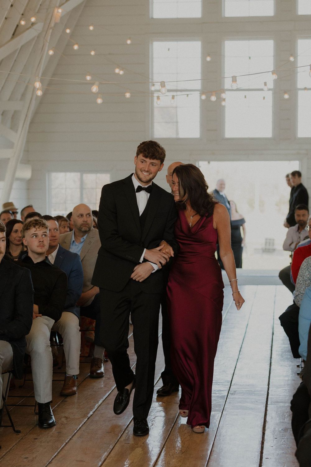 Couples dancing together in a light-filled room with wooden floors.