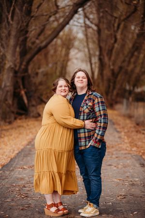 A group of heartwarming outdoor photos showing a sweet childhood friendship in a fall forest path setting.