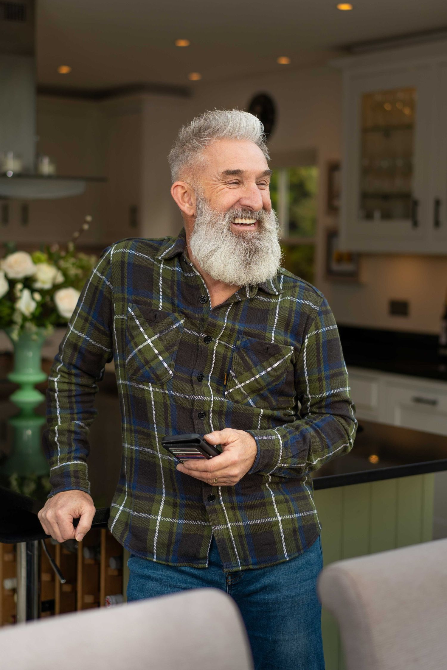 Local Winchester business owner laughs during a personal branding photoshoot in a luxury kitchen near Sparsholt.
