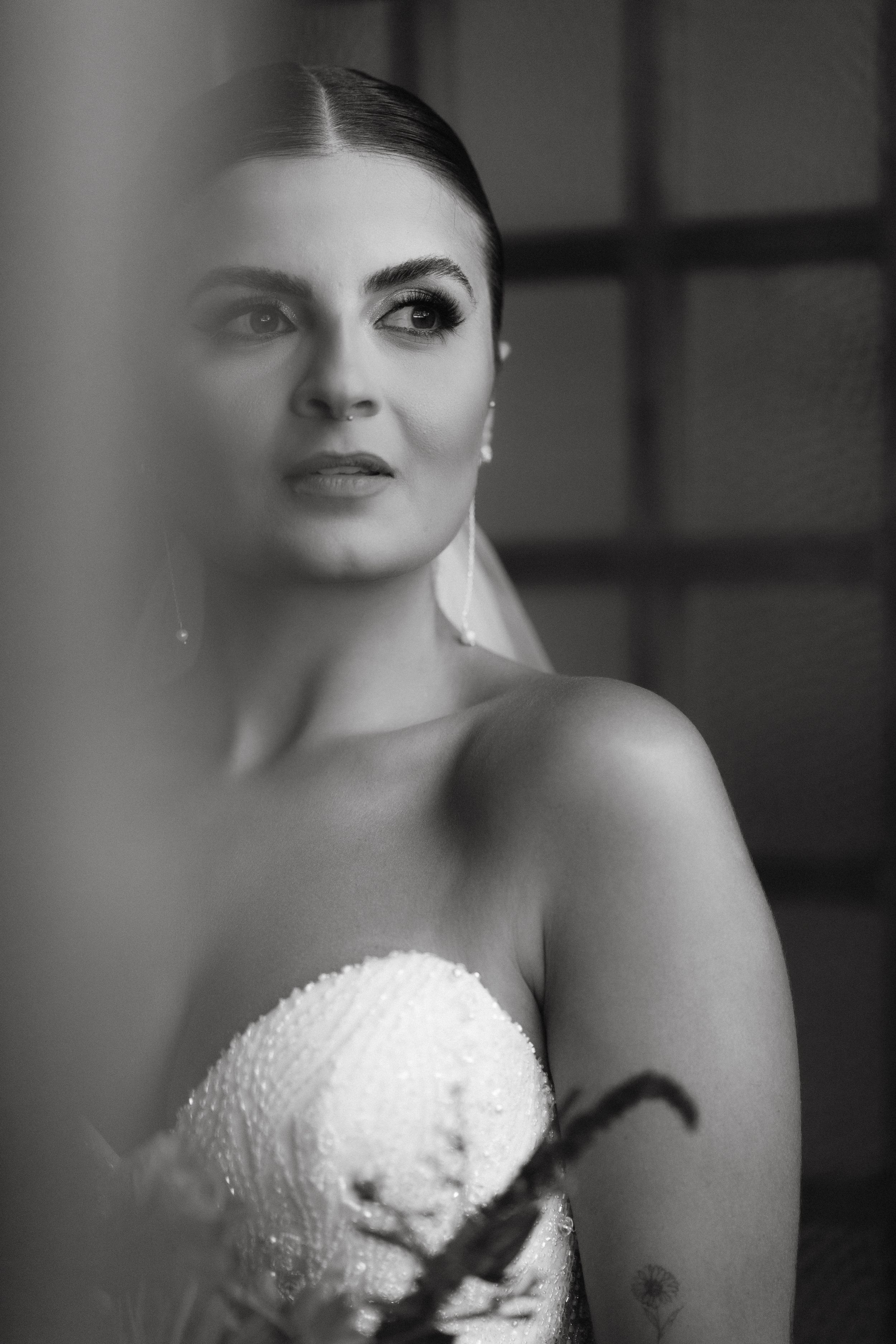 Black and white dramatic bridal portrait with soft focus and delicate lace details.