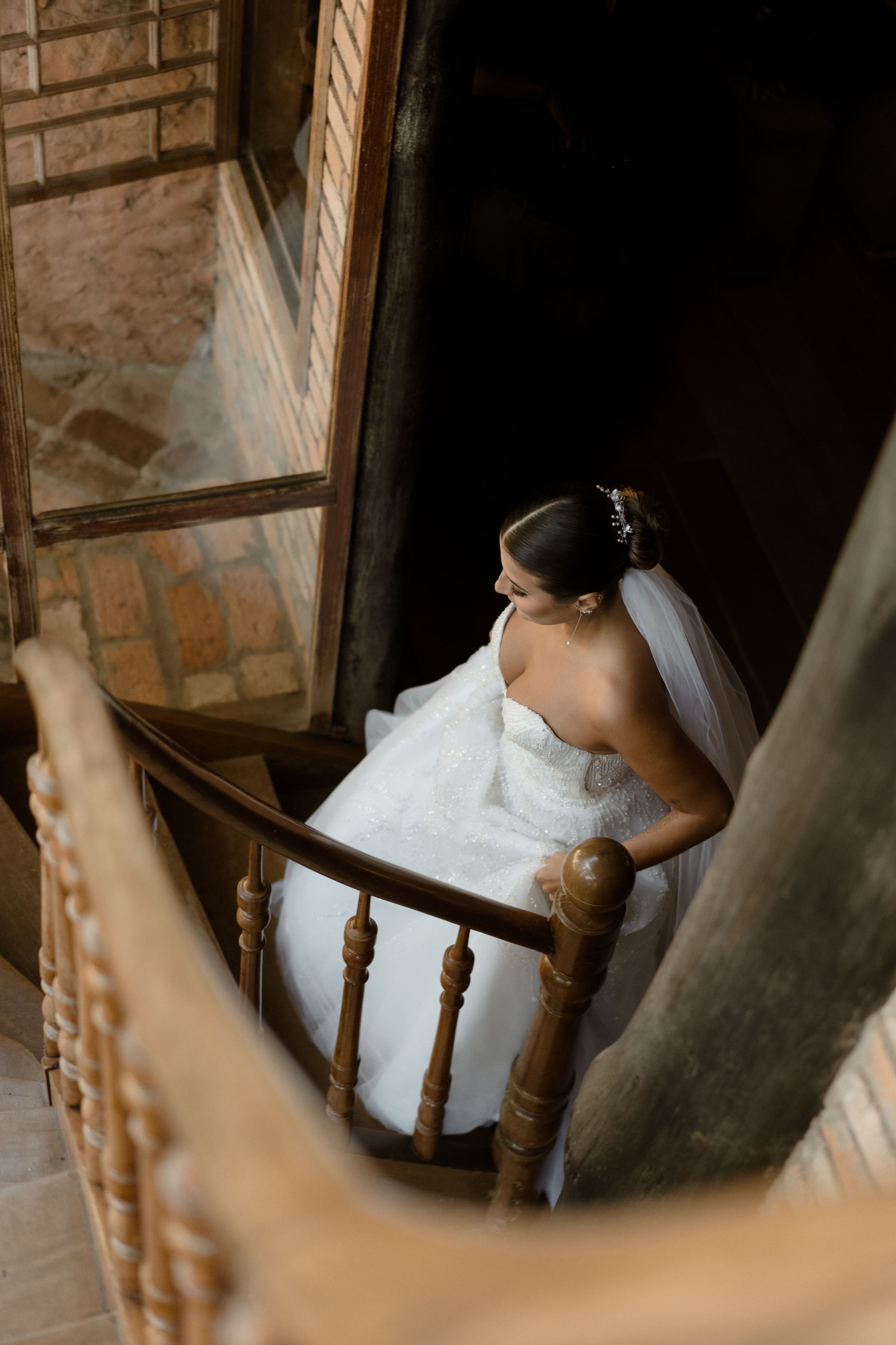 Artistic bridal portrait featuring vintage wooden chair and flowing white veil.