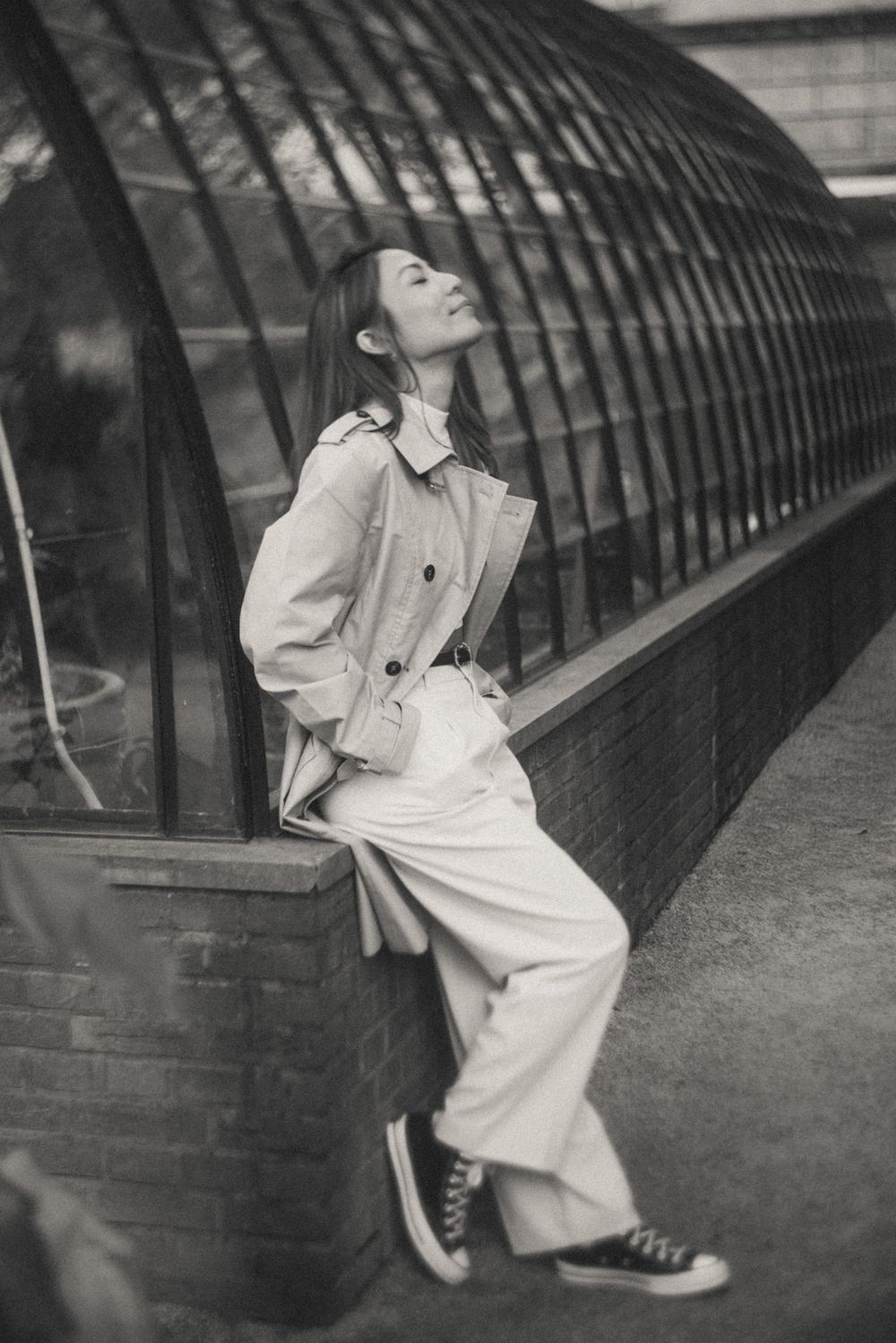 Dramatic black and white photos against curved glass greenhouse architecture.