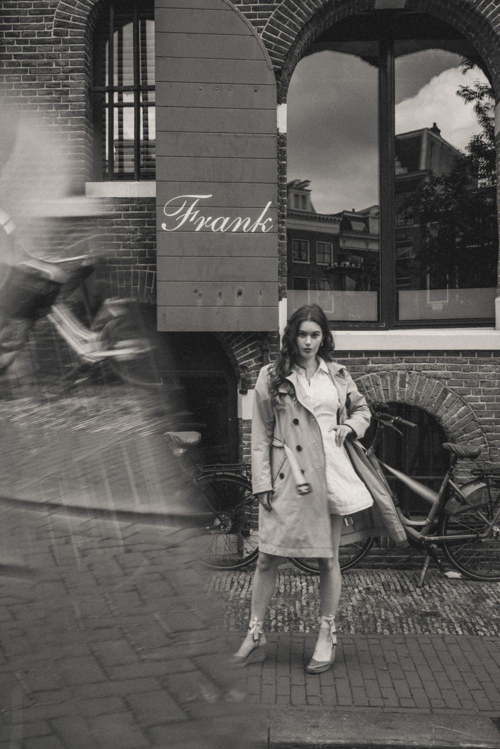 Artistic black and white photo sequence showing movement on cobblestone street.