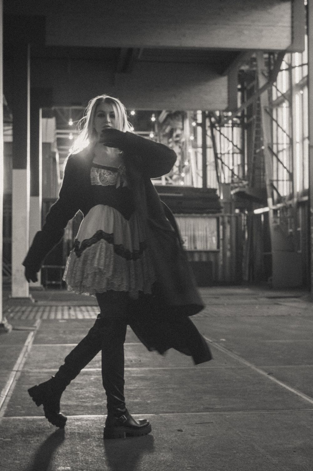 Dramatic black and white photos showing movement in an empty industrial space.