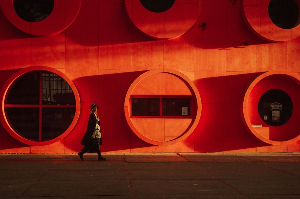 Abstract architectural detail with red illuminated circular openings.