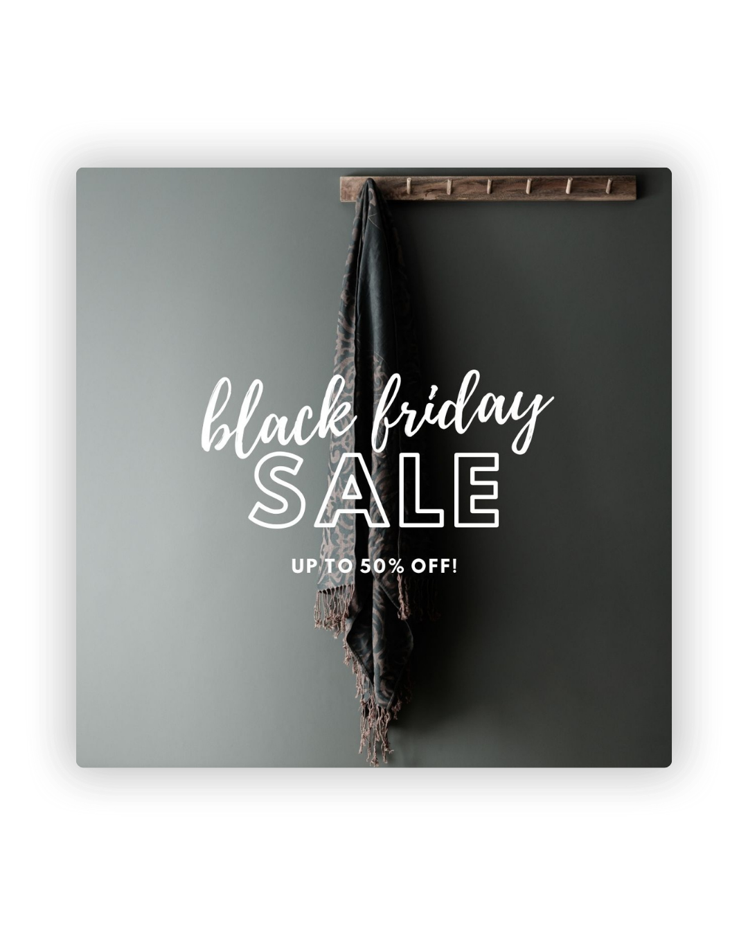 Black Friday sale promotion with white text on dark wall showing up to 50 percent off discount offer.