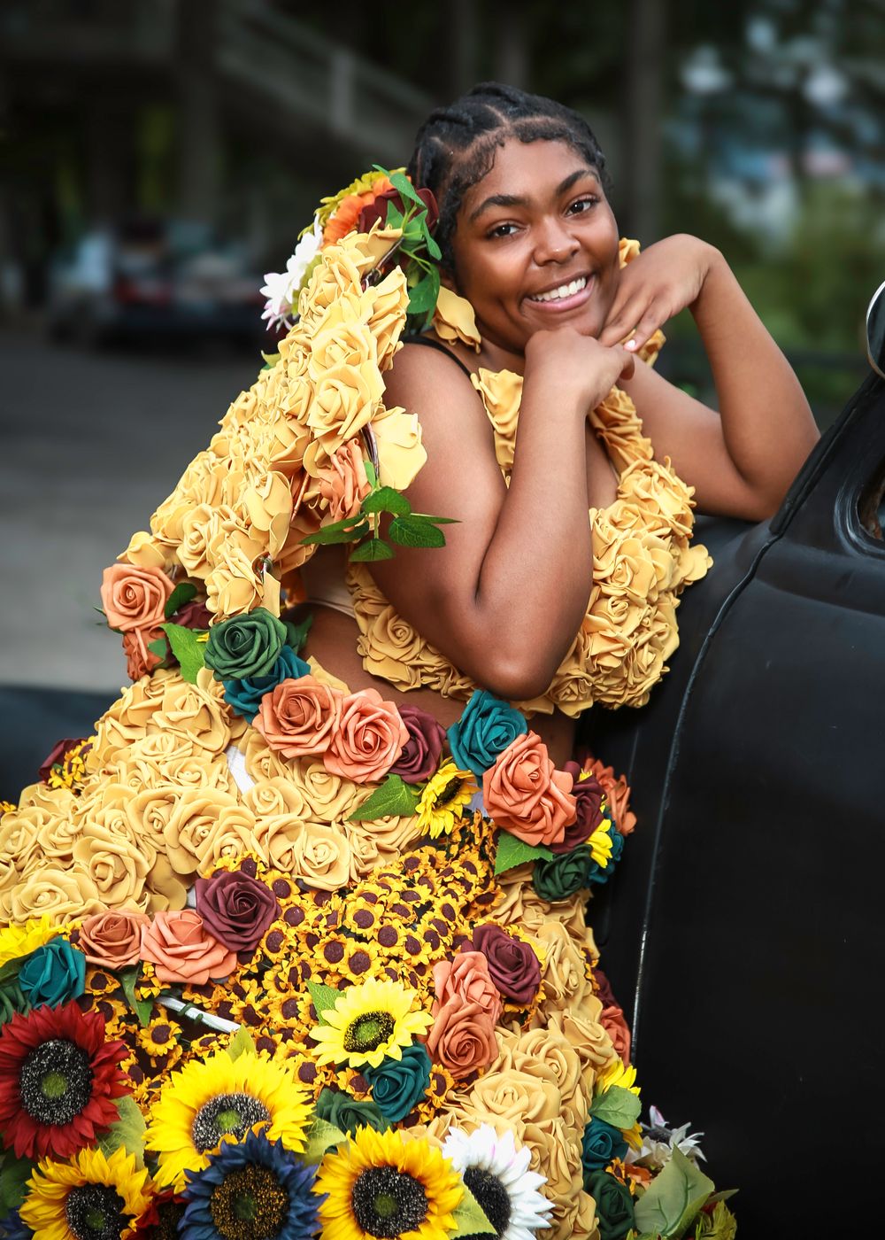 Beautiful floral dress design adorned with yellow roses, sunflowers, and peach-colored blooms creates a stunning garden-inspired look.