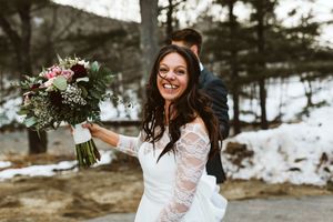 Wedding celebration scene with lace dress details in a winter forest setting.
