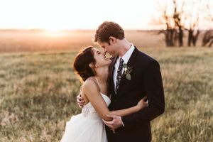 Romantic sunset wedding photos captured in a golden field.