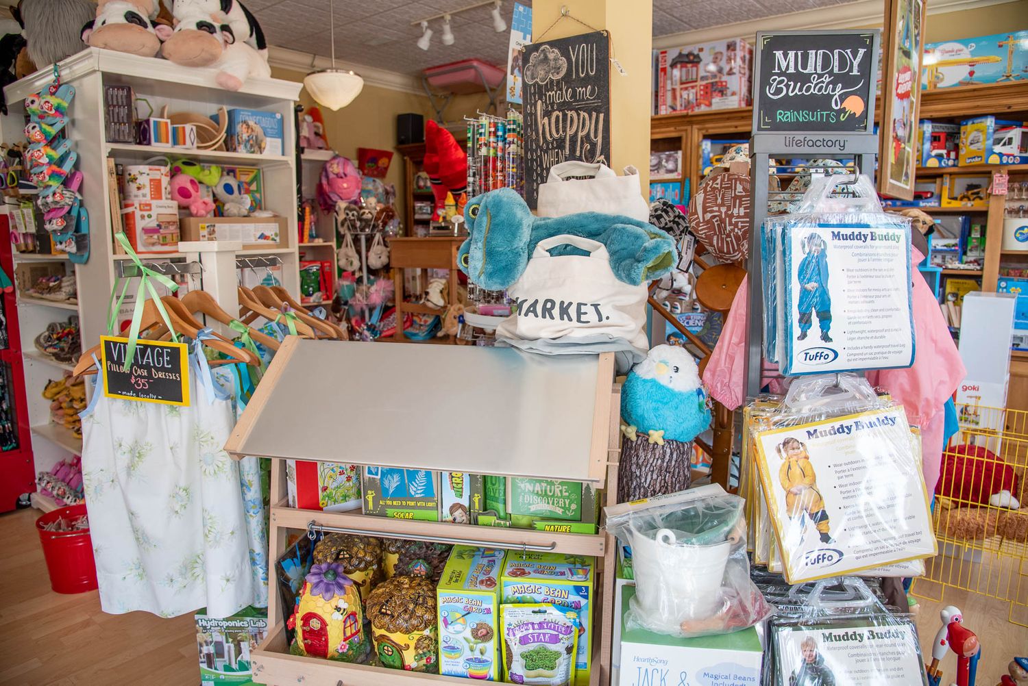 Interior shot of a cozy toy store with shelves displaying children's books, toys, and colorful merchandise.