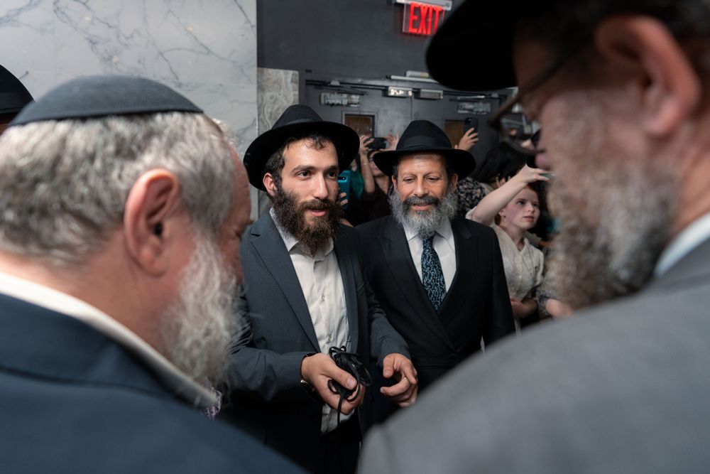 A group gathers for conversation at an indoor religious event.