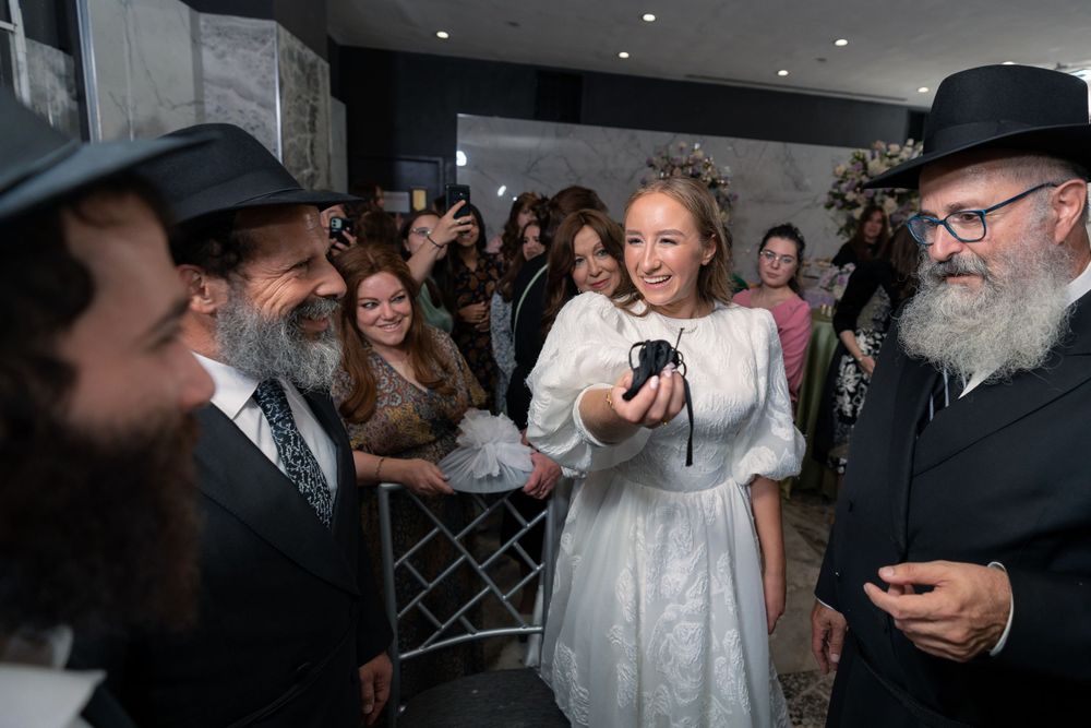Guests celebrate at a festive Jewish wedding celebration.