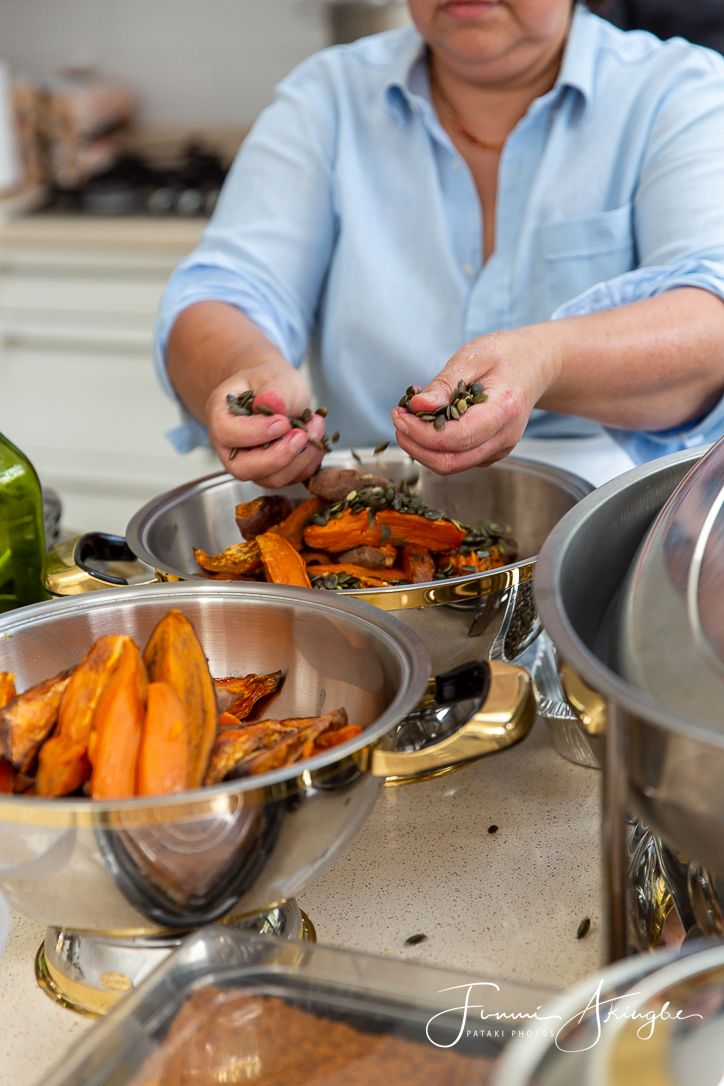 Roasted vegetables food preparation in stainless steel serving dishes.
