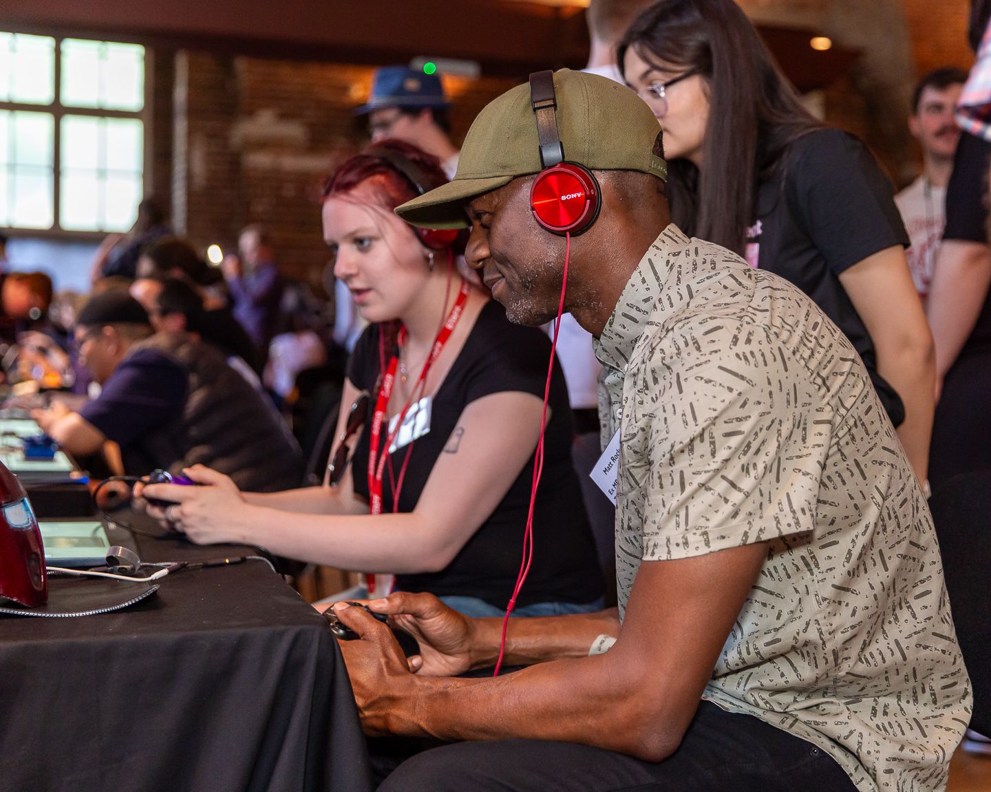 Guests at the NextGen skills academy graduate showcase event held in London, playing a video game designed by one of the students