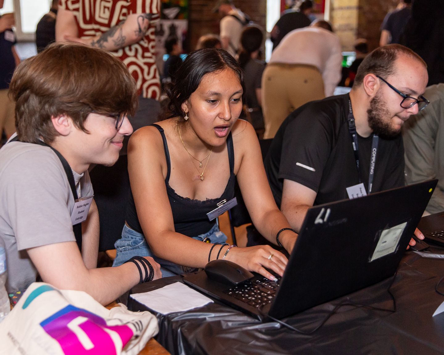 Guests at the NextGen skills academy graduate showcase event held in London, playing a video game designed by one of the students