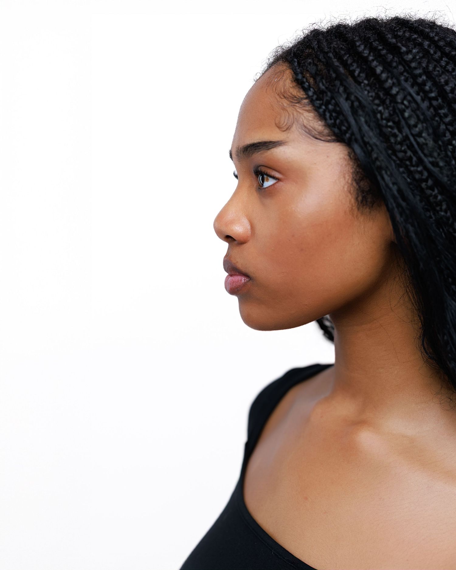 Profile portraits showing different angles of a person wearing a black headwrap against white background.