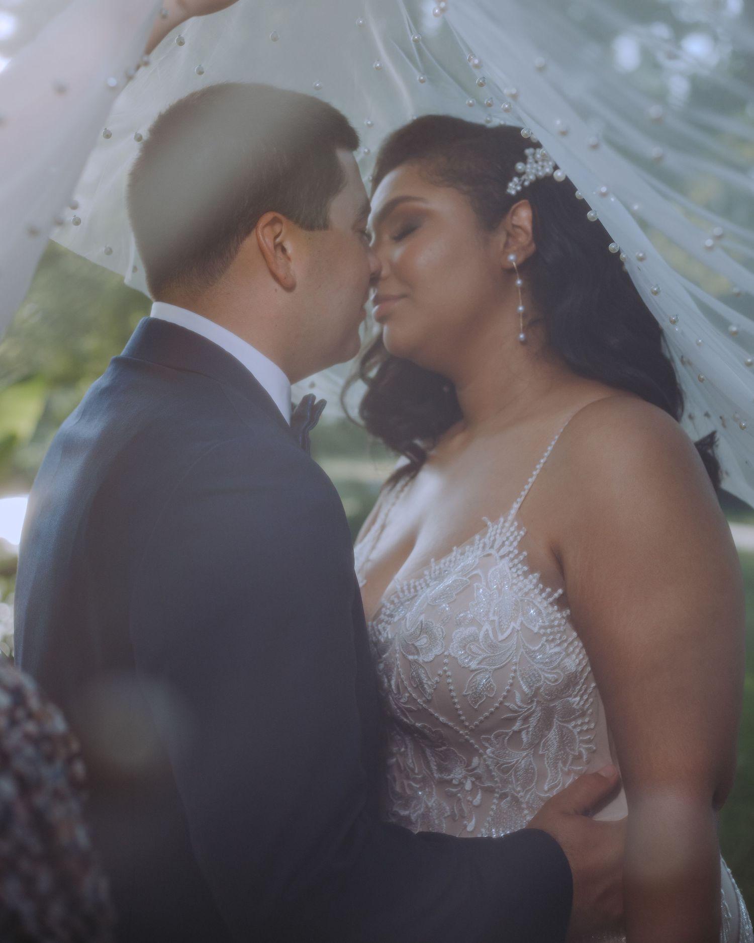 Portrait of a bride in a white strapless wedding dress and veil with elegant makeup and jewelry on her wedding day.