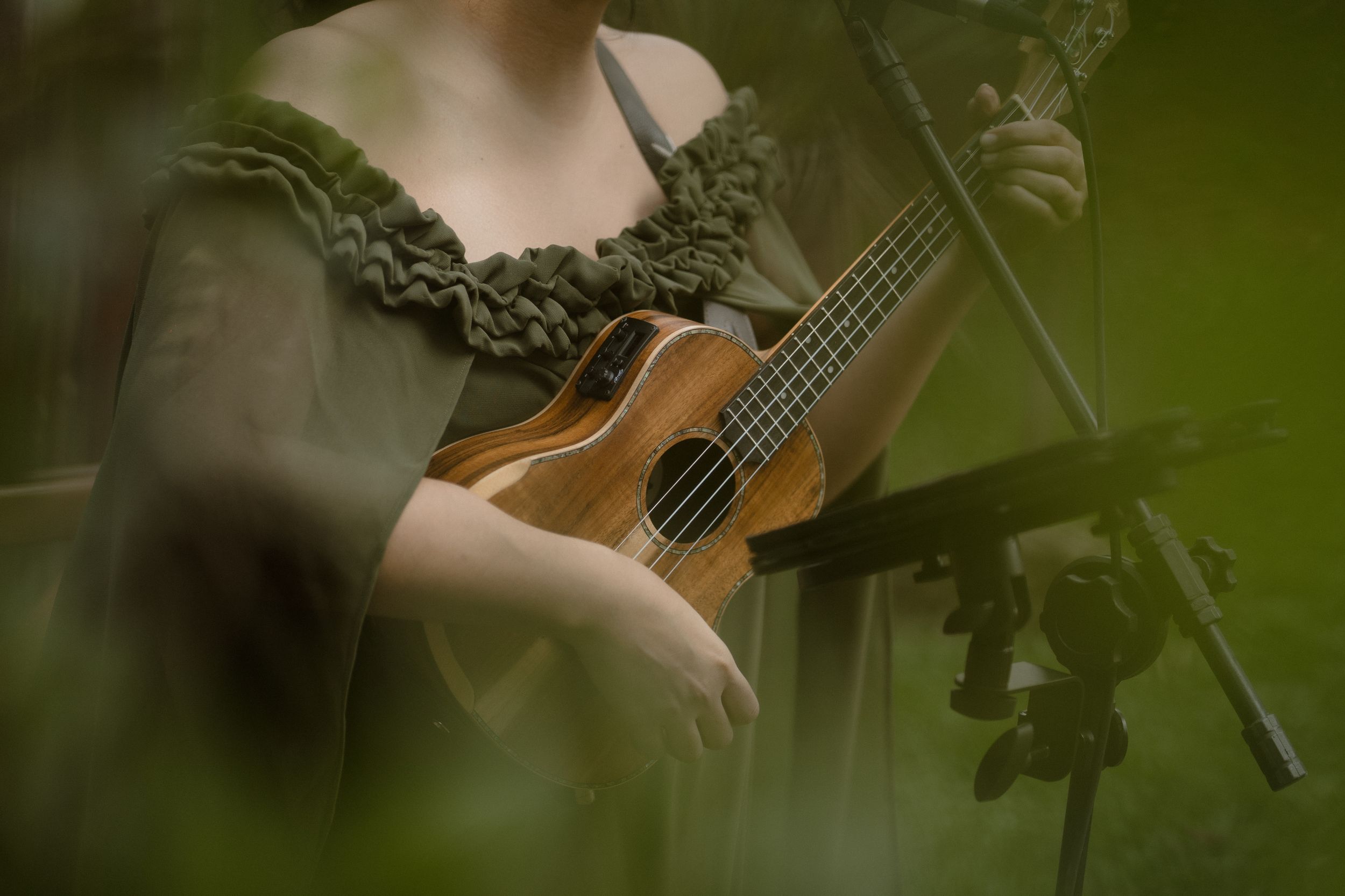 Close-up shot of musical instruments being played during an outdoor performance.