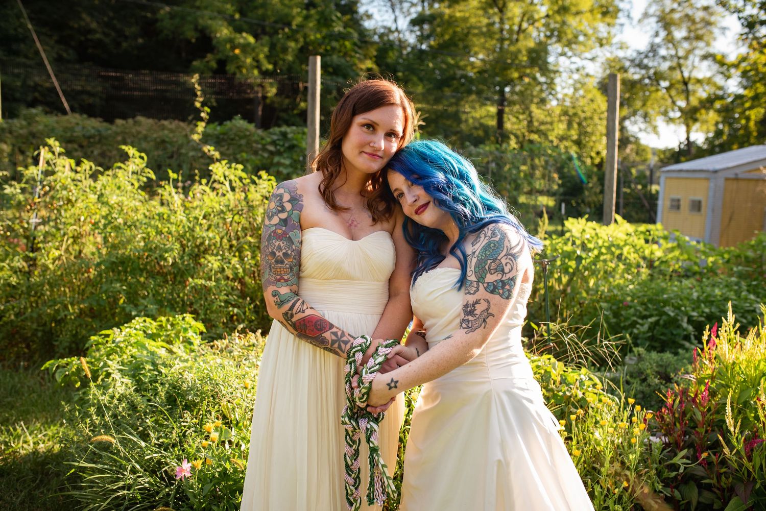 Wedding ceremony in a lush garden setting with white draping and floral arrangements.