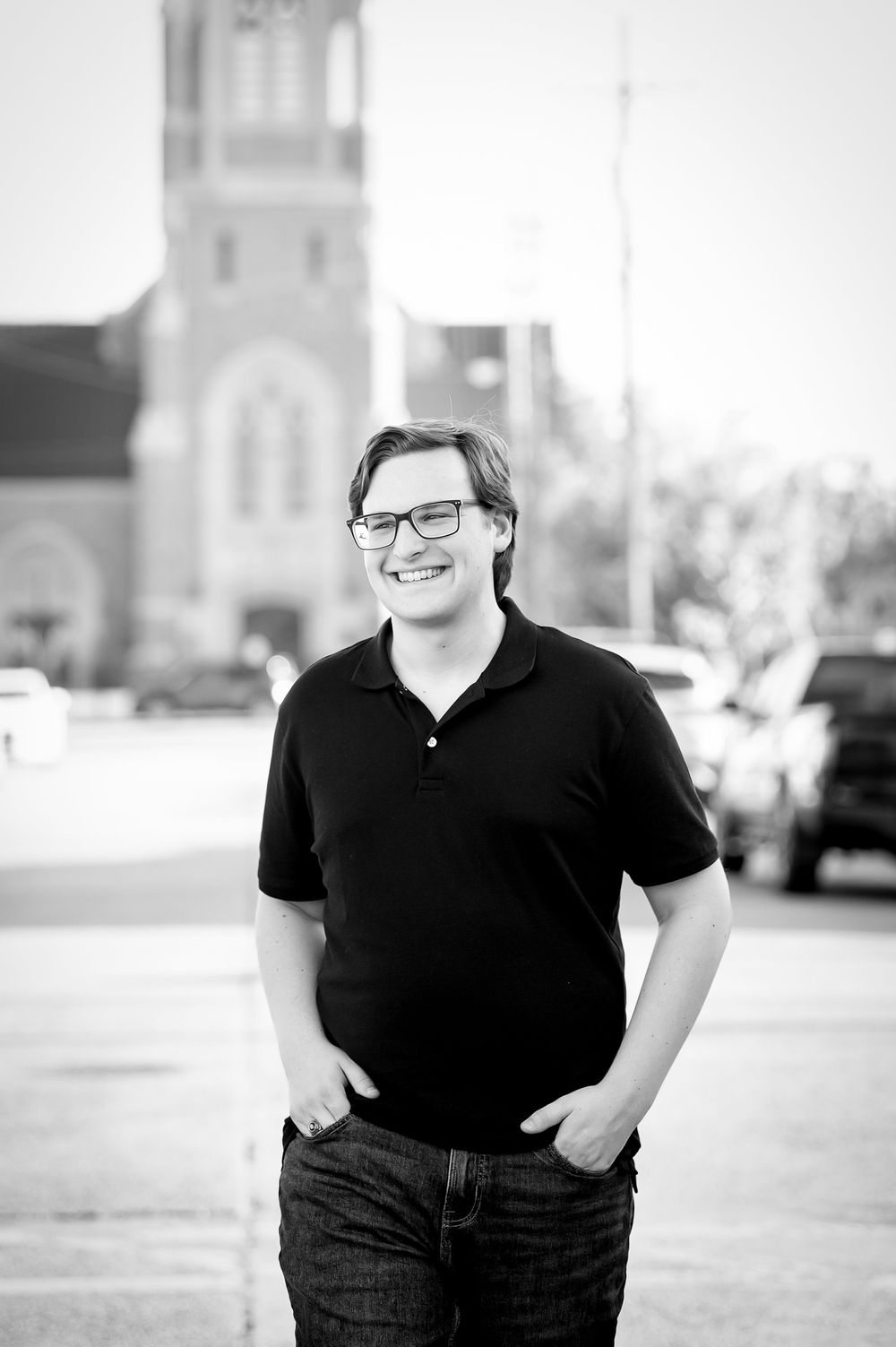 Black and white portrait series in urban setting with church architecture visible.