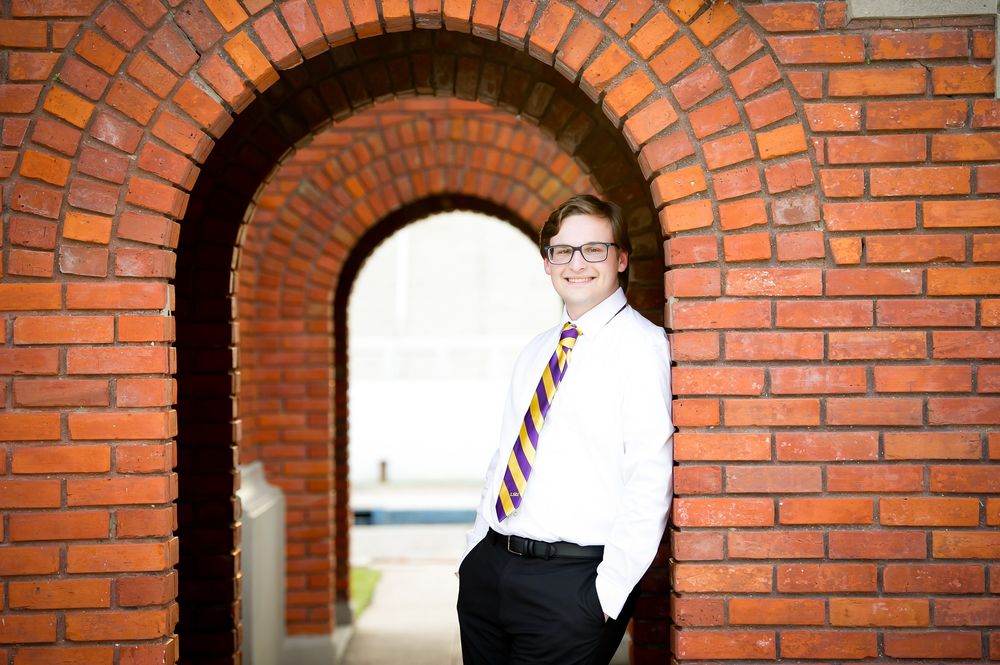 Portrait series against red brick archways with dramatic lighting and architectural framing.