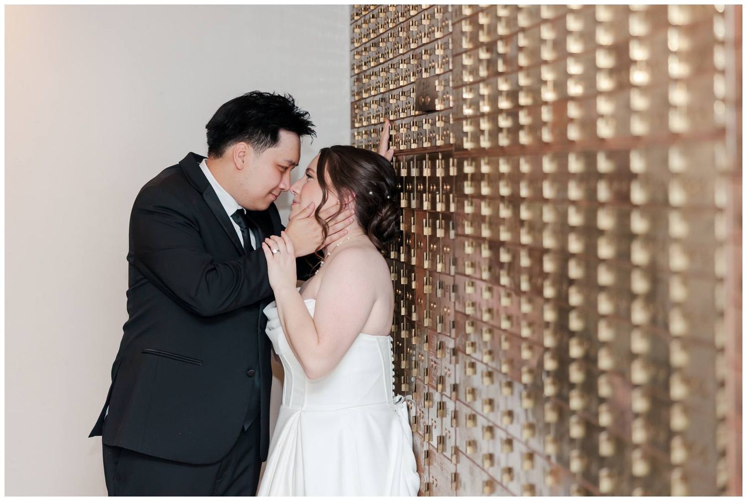 Couple shares intimate moments against modern geometric wall backdrop.