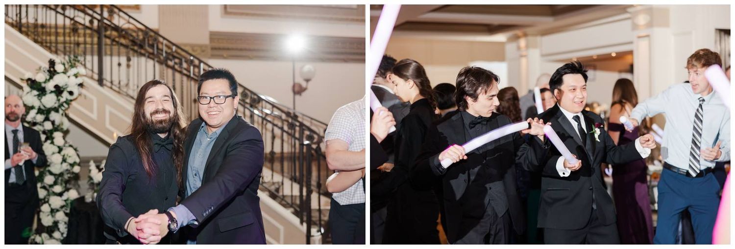 Wedding guests celebrate and dance during indoor reception party.