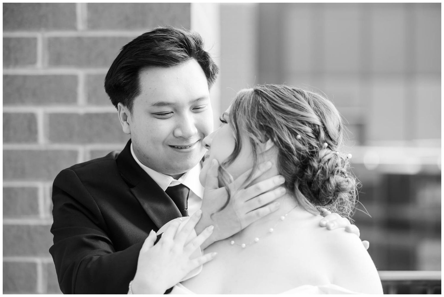 Black and white wedding portraits capture tender moments between newlyweds in elegant attire.