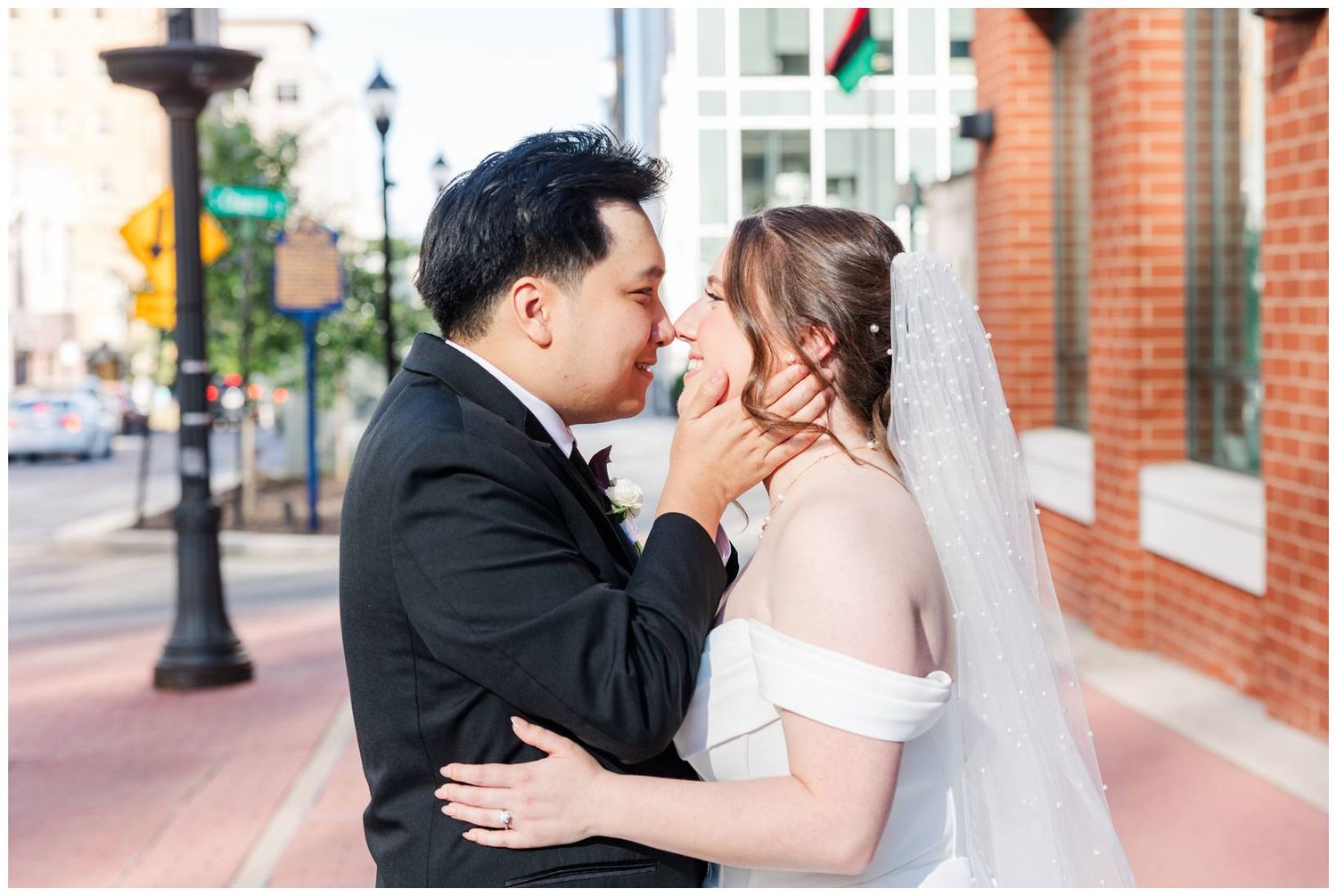 Romantic wedding portraits captured against classic brick architecture and city streets.