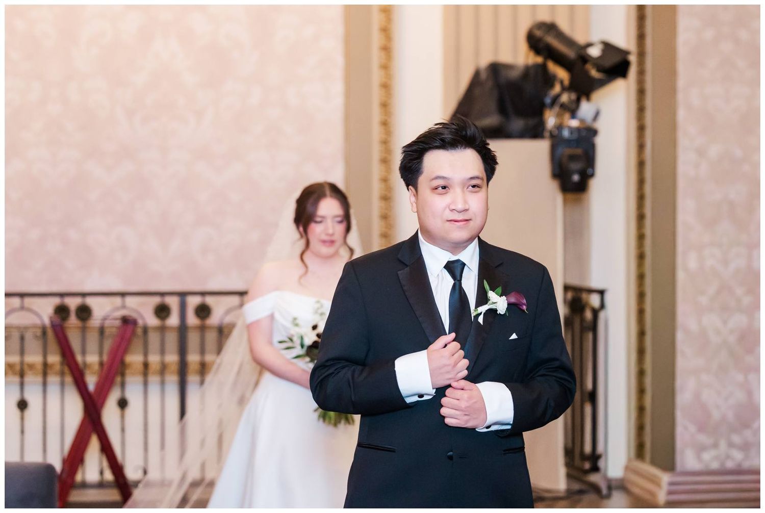 A couple shares a special moment during their wedding ceremony in an elegant venue.