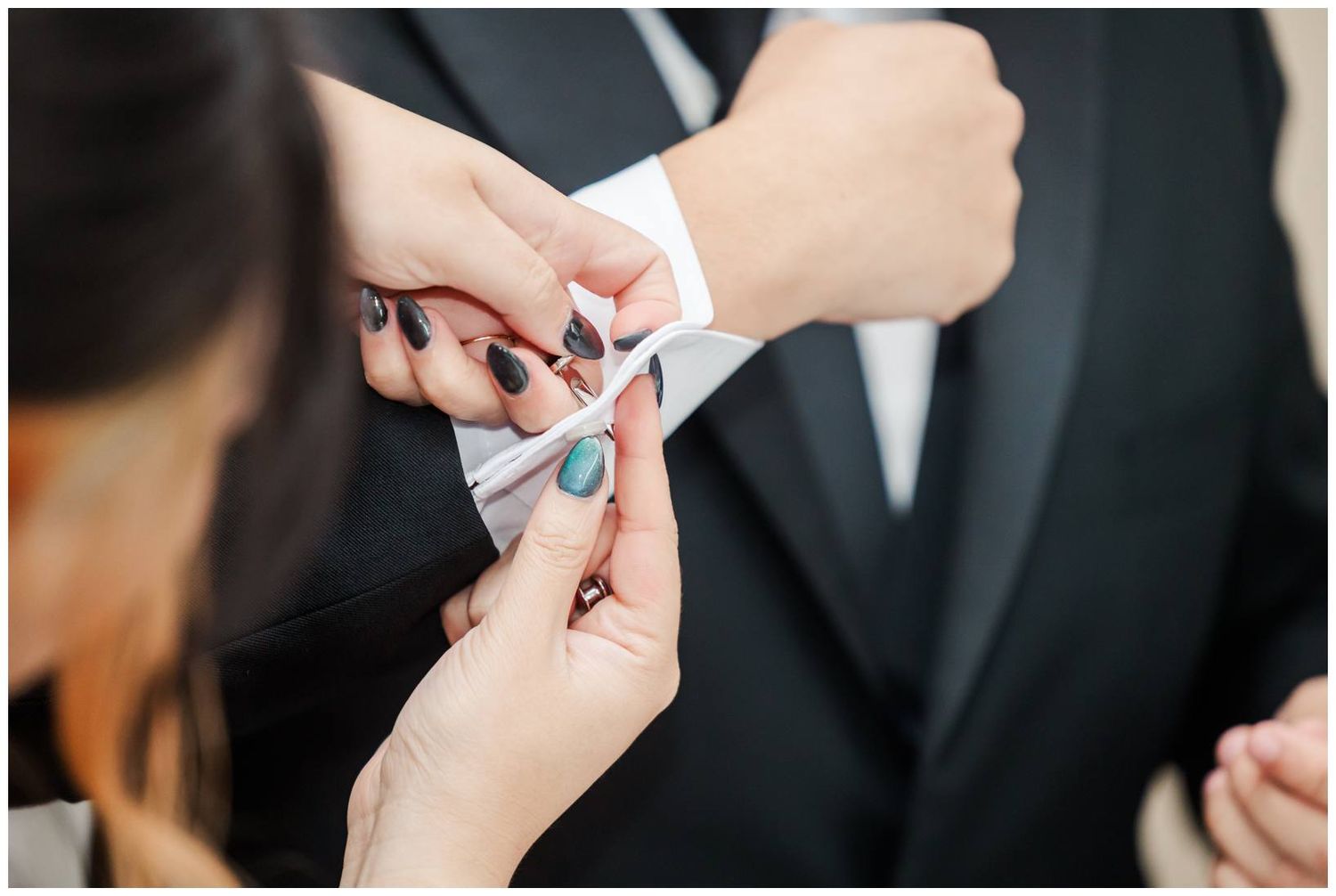 Close-up shot of hands exchanging wedding rings during a traditional marriage ceremony.