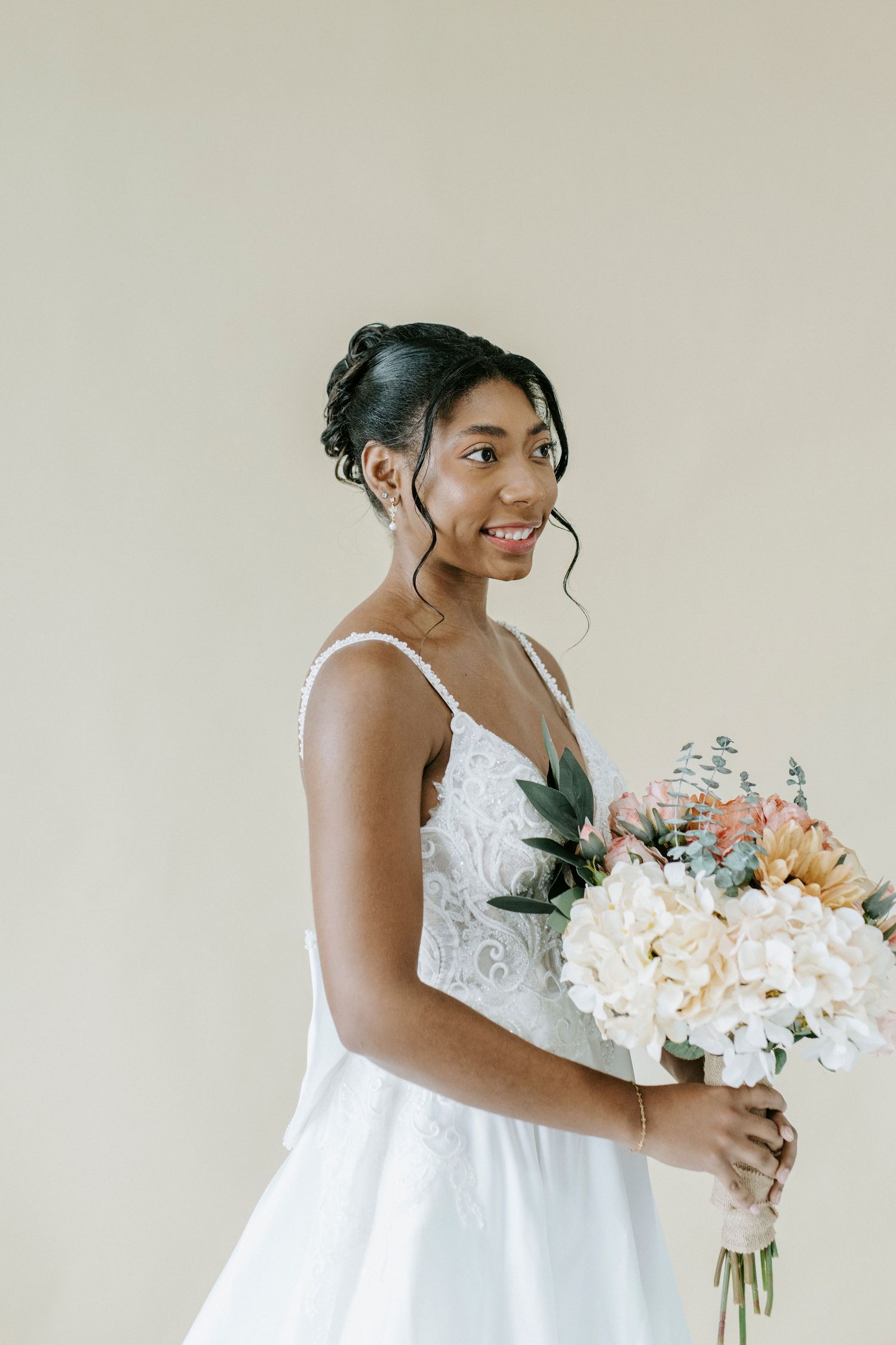A series of elegant bridal portraits showing someone in a white wedding dress holding a soft pastel floral bouquet.