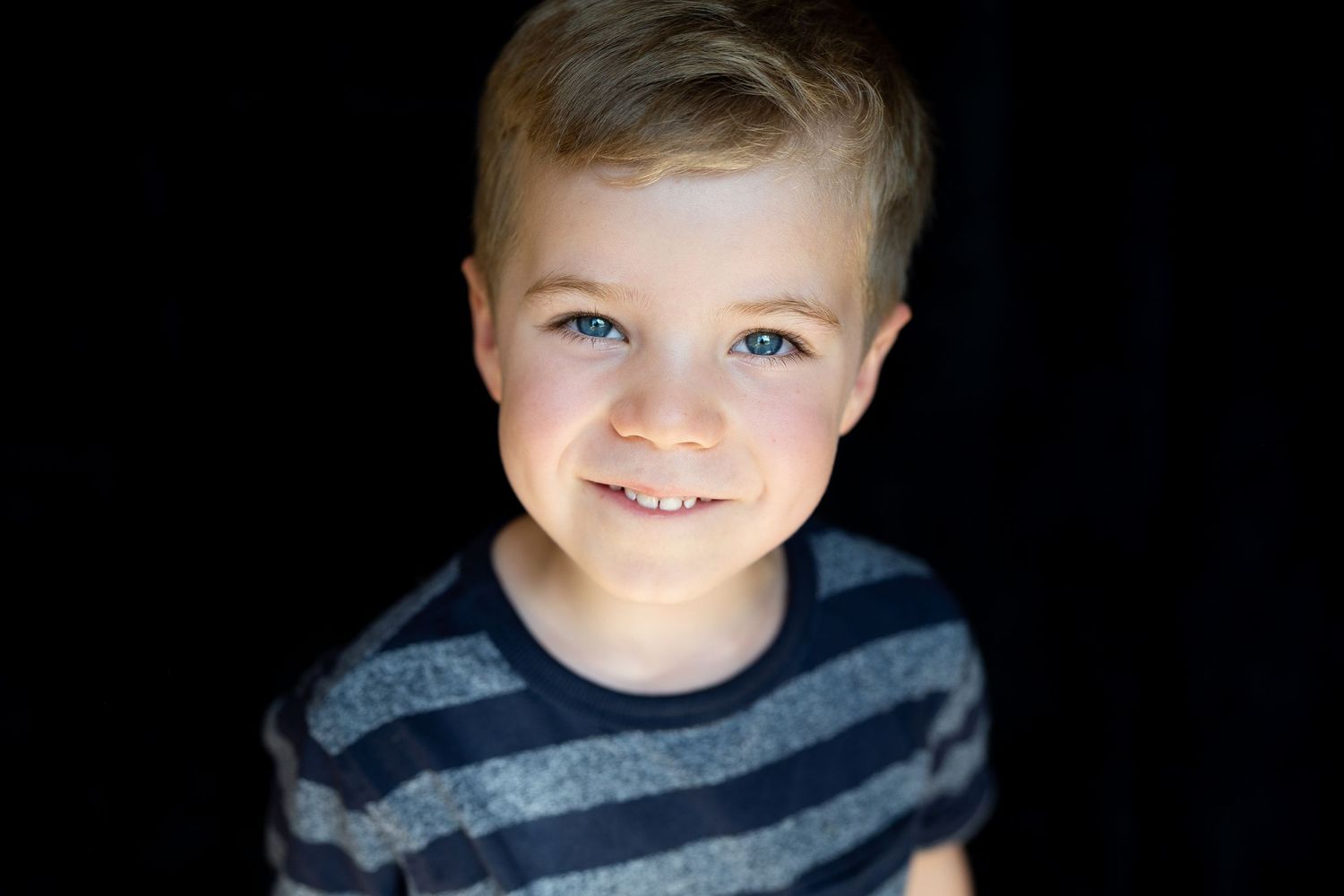 Fine art school portrait of a child against a black backdrop
