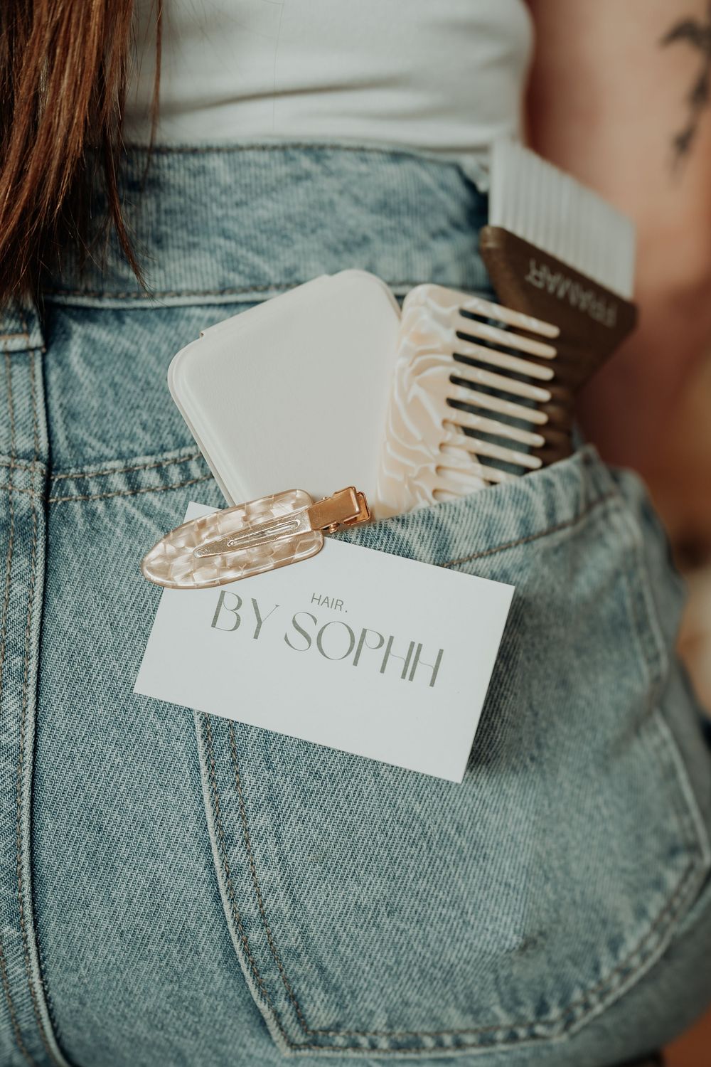 Close-up gladstone product photography of light wash denim with branded tags.