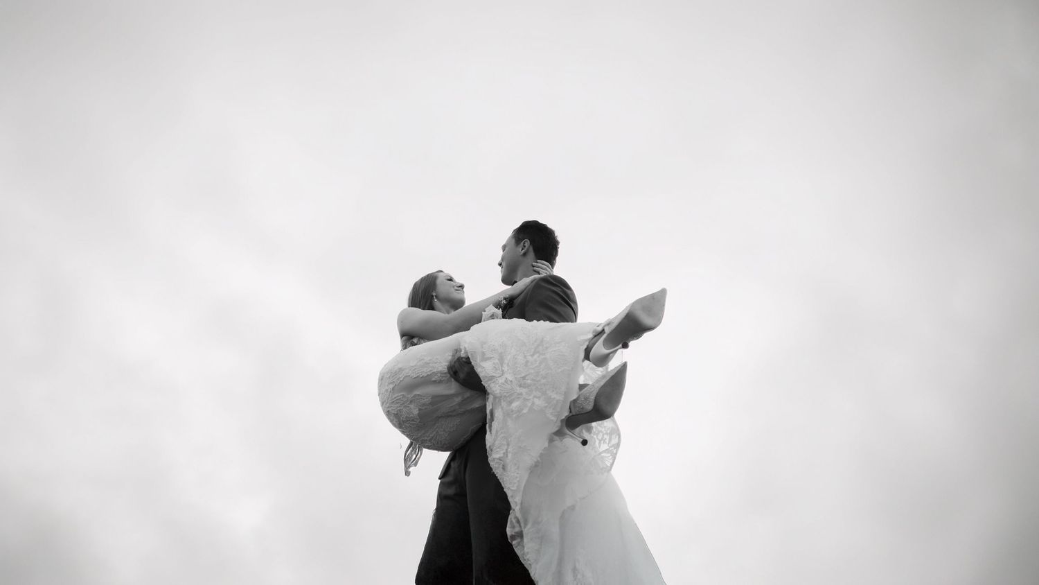 A series of black and white photographs showing two dancers performing a graceful contemporary dance sequence.
