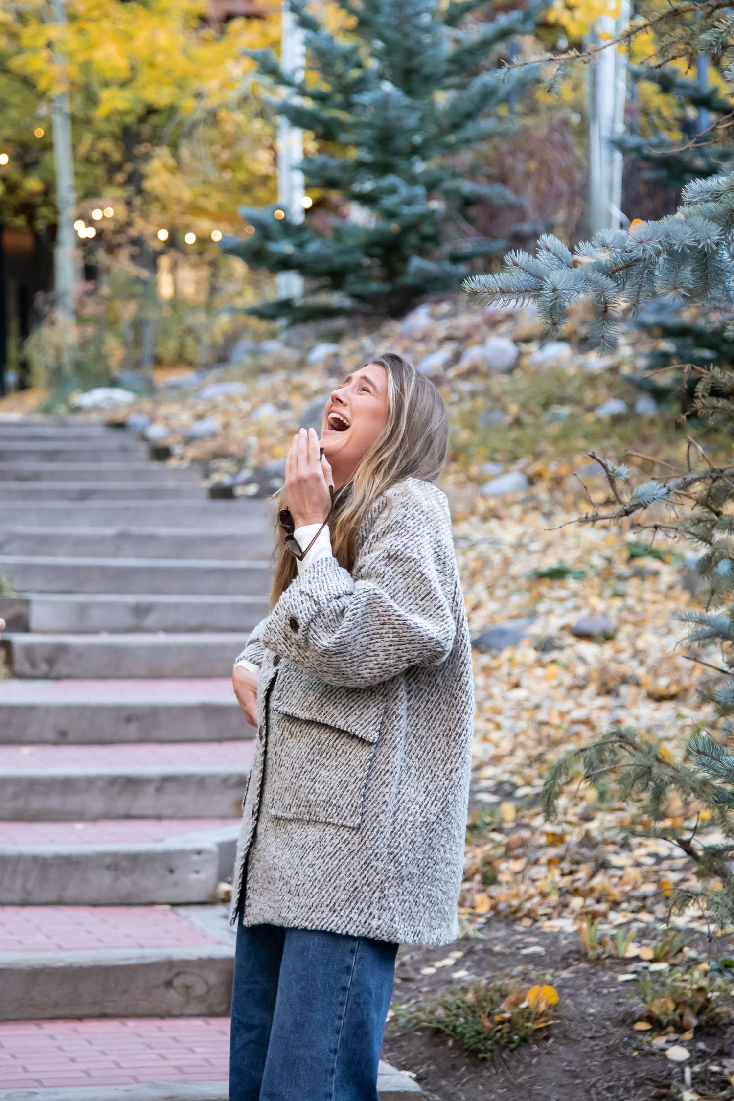 A candid reaction of a woman after a surprise proposal in Vail Village Colorado