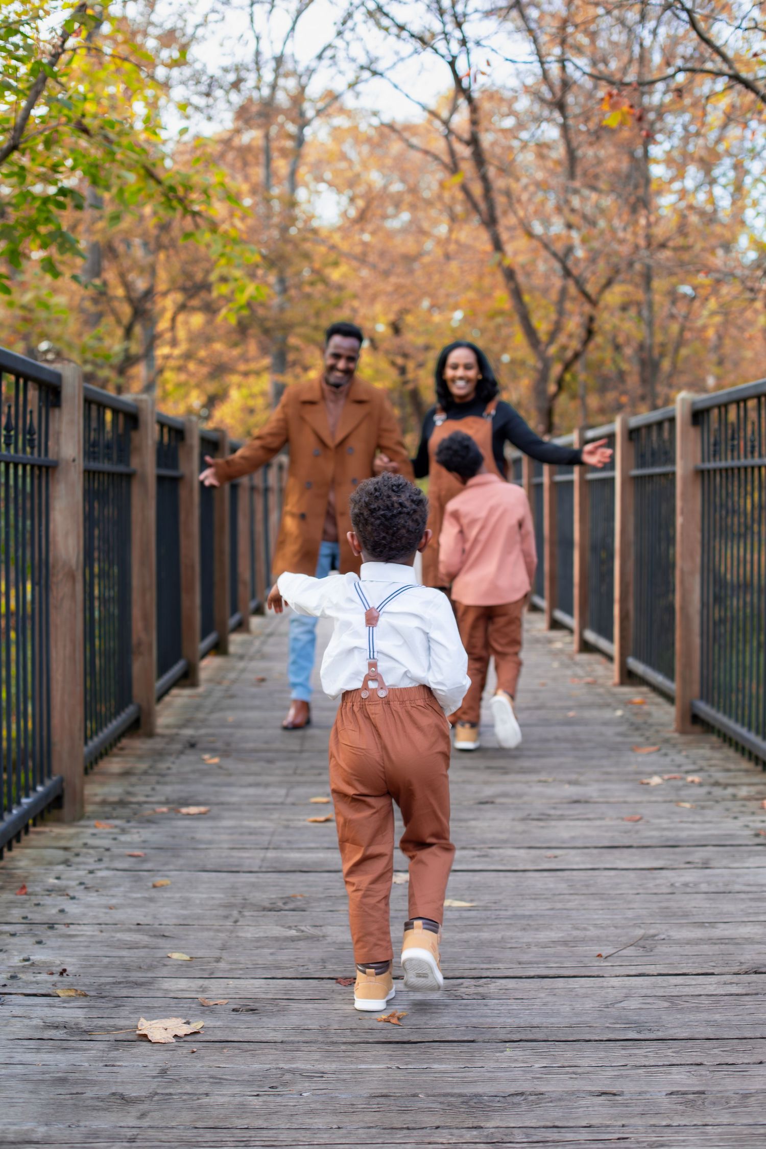 Sharon Woods fall family photos in Cincinnati featuring two family portraits with warm autumn colors, candid connection & outdoor session