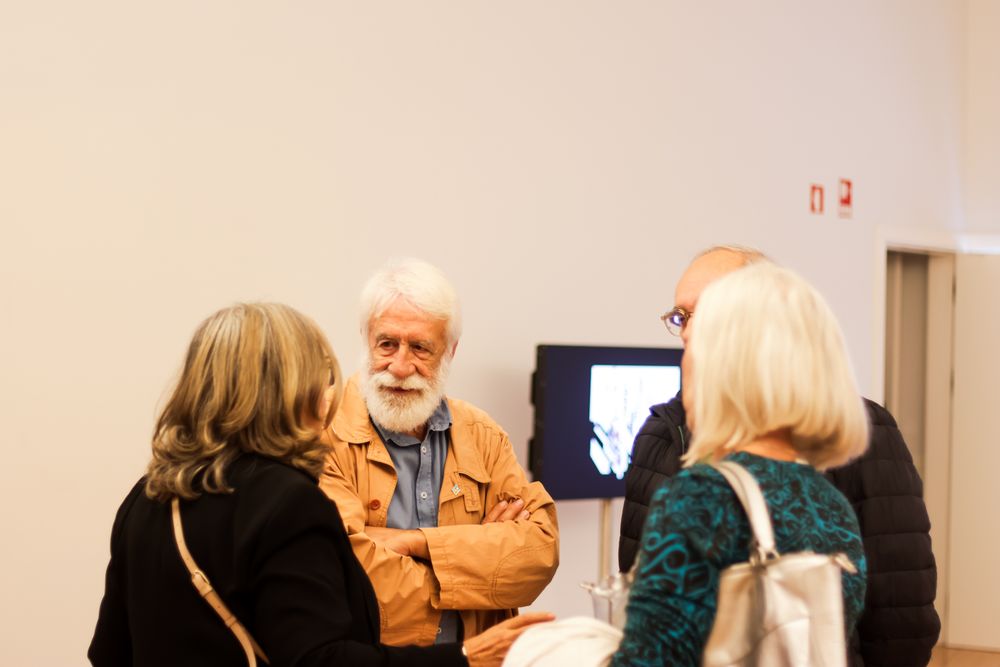 People browsing in a bright indoor space with white walls.