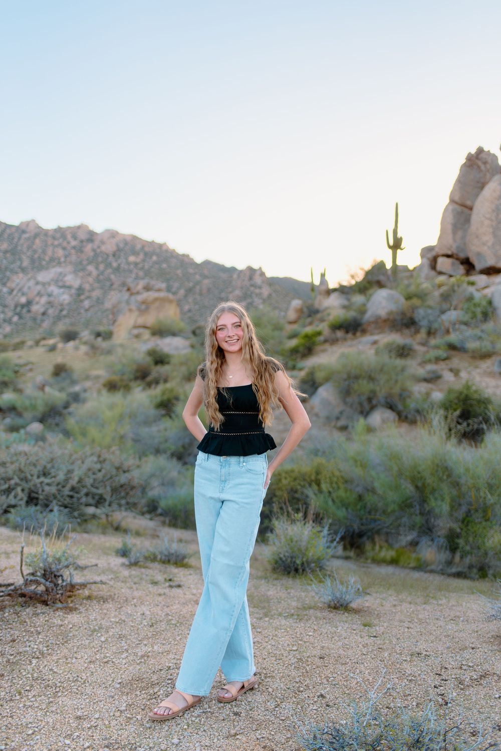 Image of a high school senior taking her senior photos  out in the desert at the McDowell Sonoran Preserve in Scottsdale, Arizona.