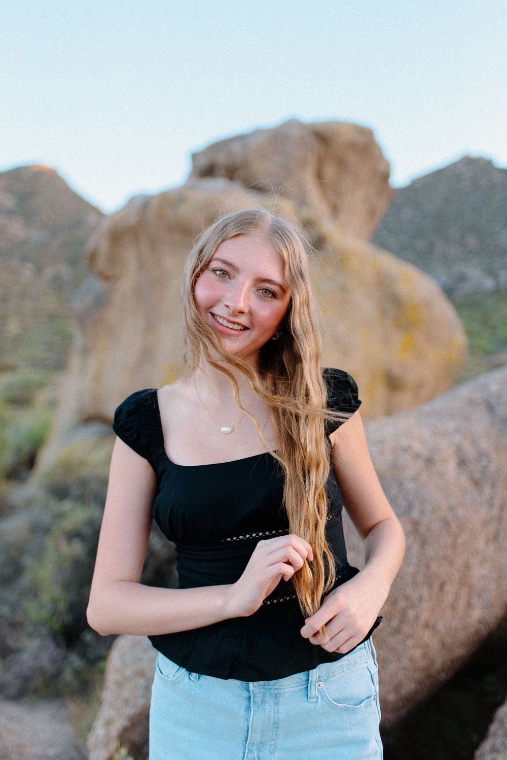 Image of a high school senior taking her senior photos at the McDowell Sonoran Preserve in Scottsdale, Arizona.