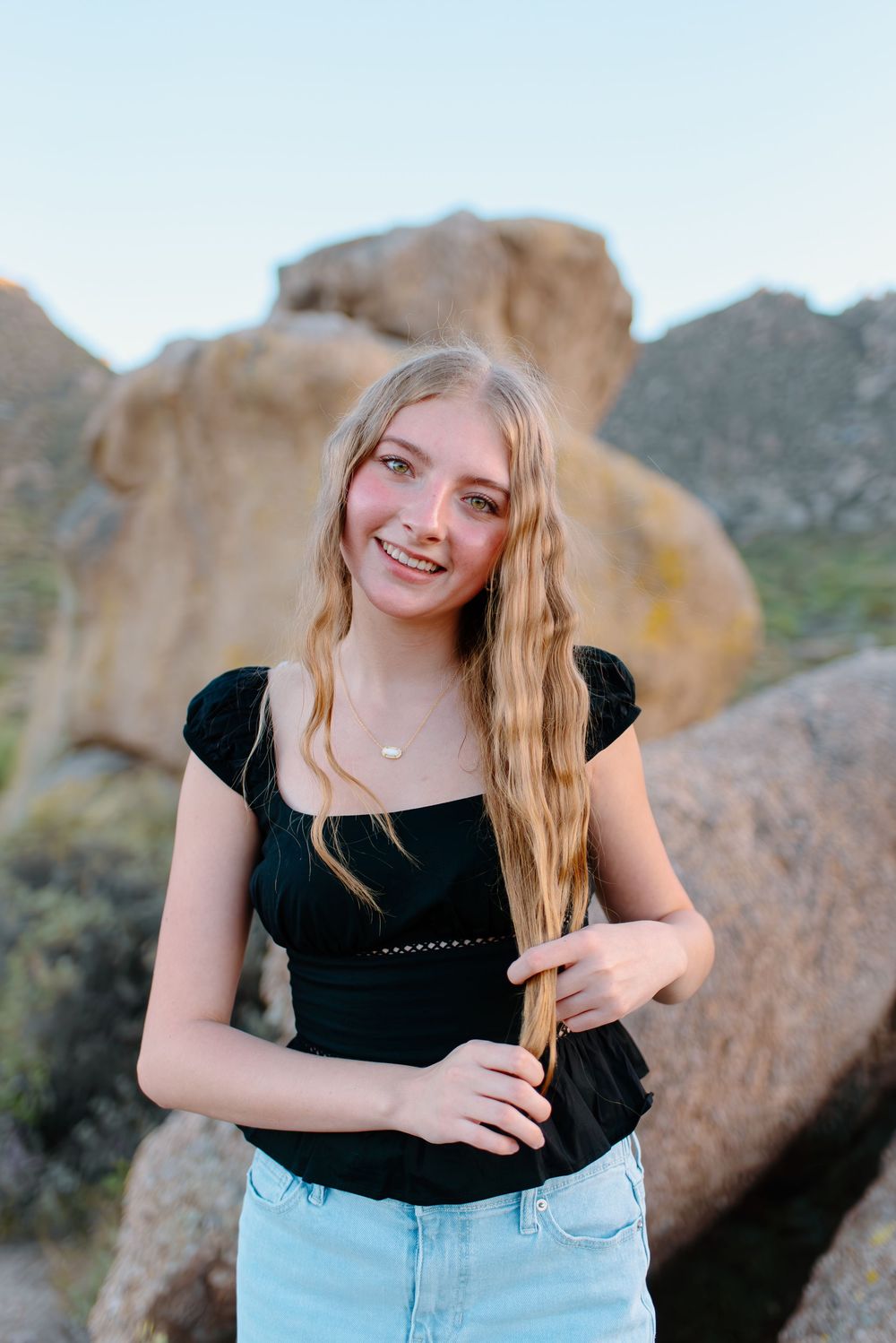 Image of a high school senior taking her senior photos at the McDowell Sonoran Preserve in Scottsdale, Arizona.