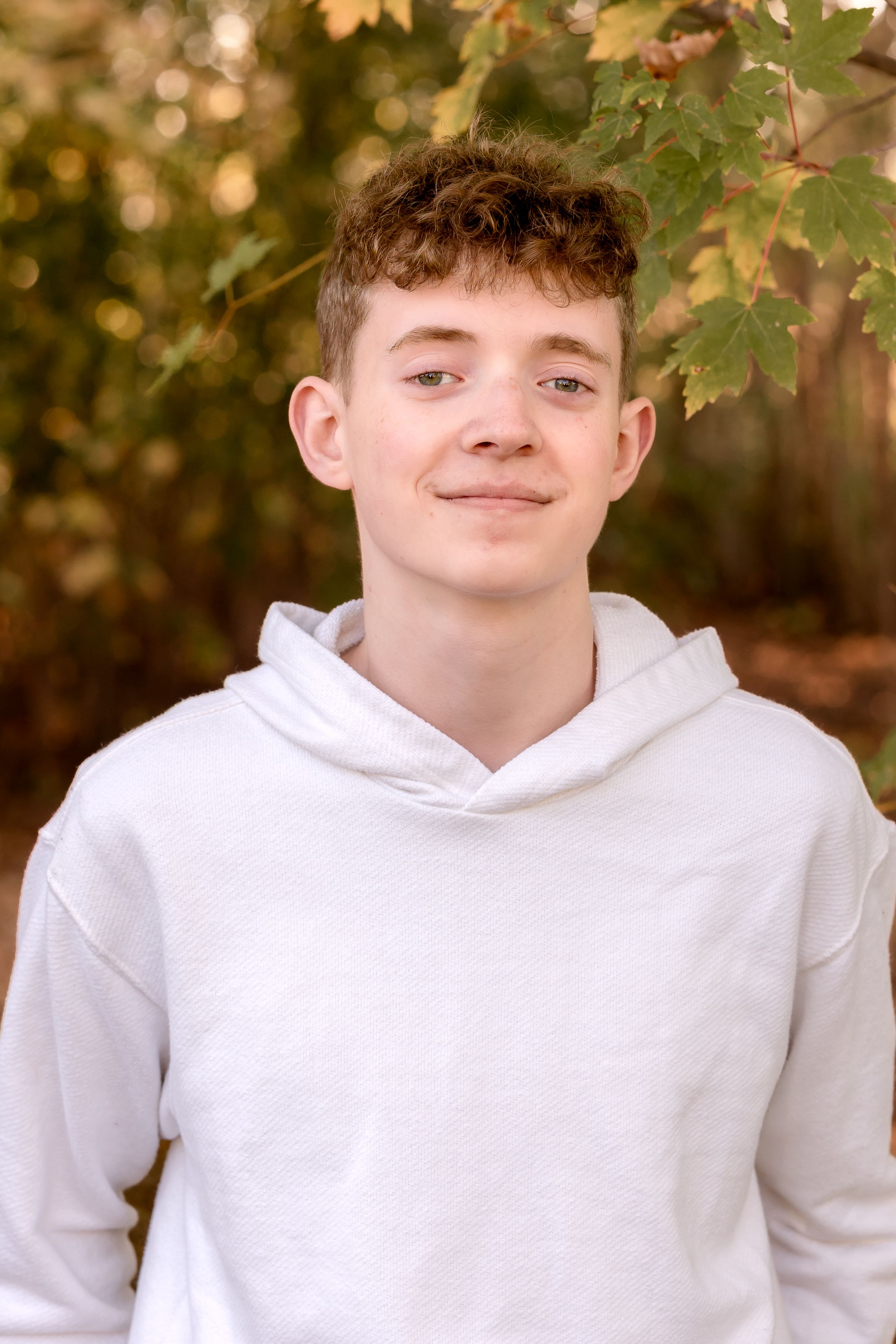Autumn outdoor portraits with golden leaves and natural lighting.
