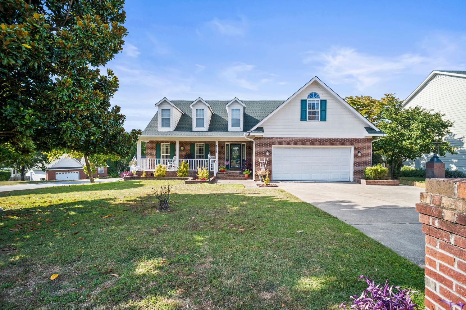 Front view of suburban homes with landscaped yards and driveways.