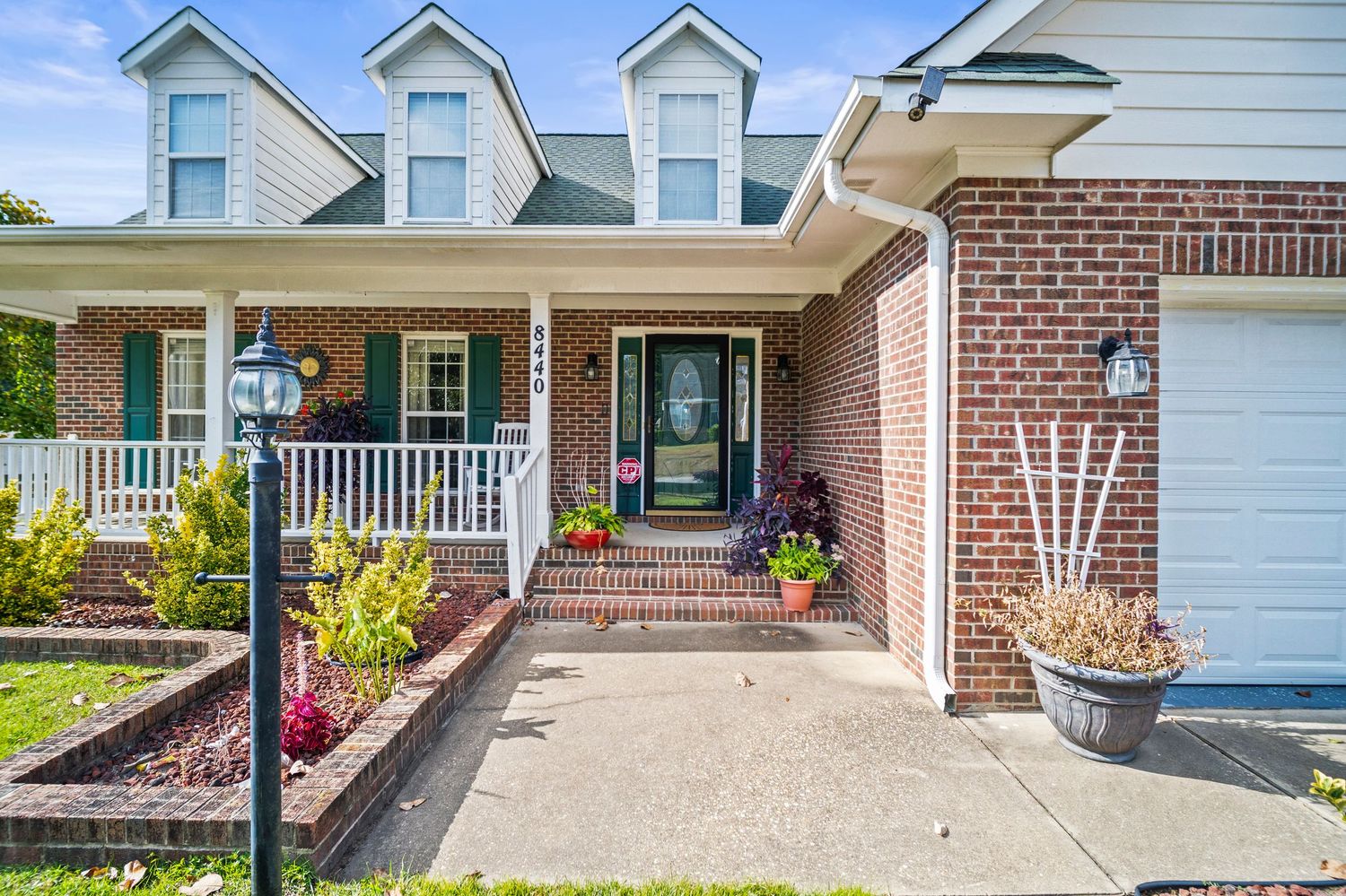 Exterior views of residential homes with attached garages and front porches.