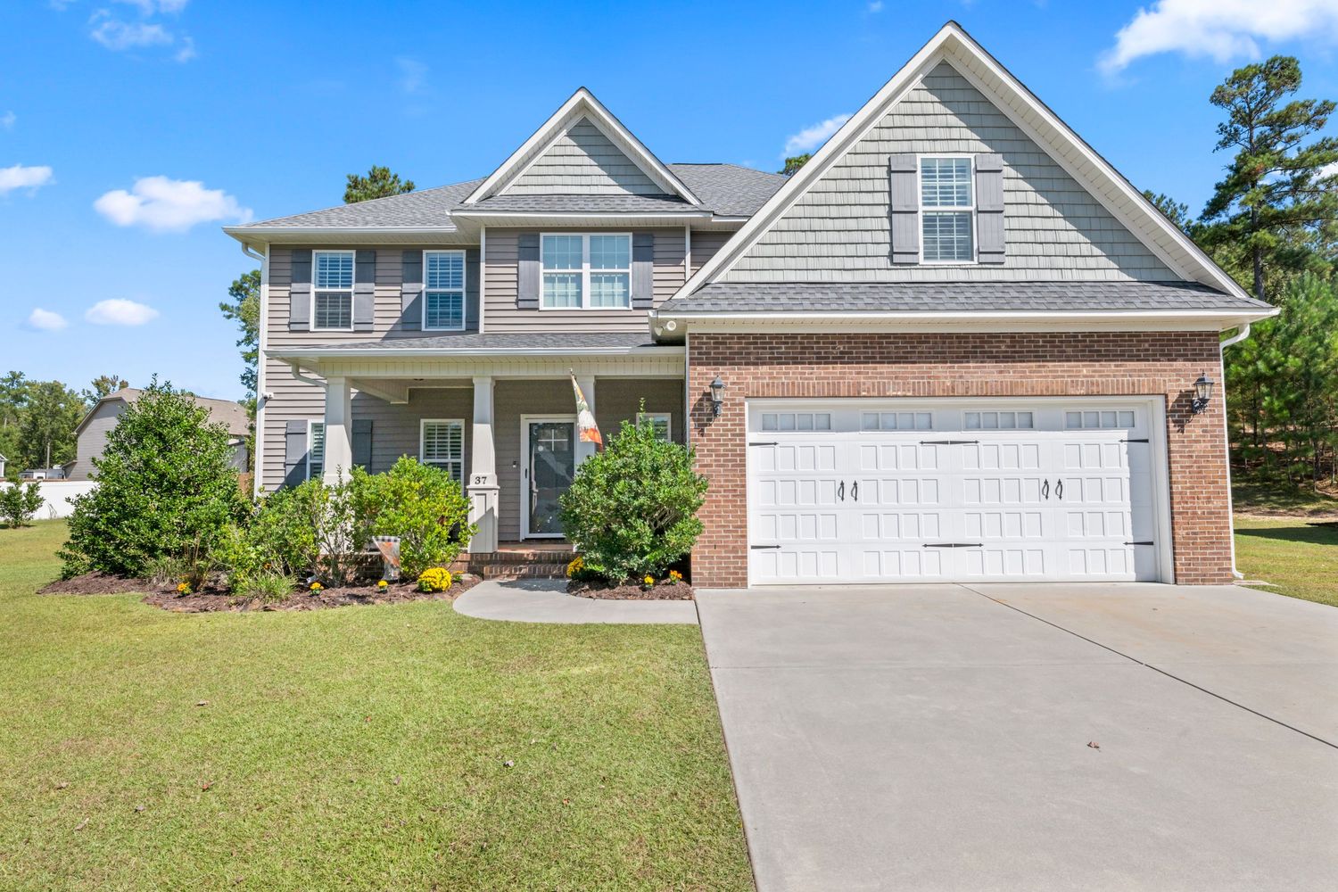 Front view of modern suburban homes with attached garages and paved driveways.