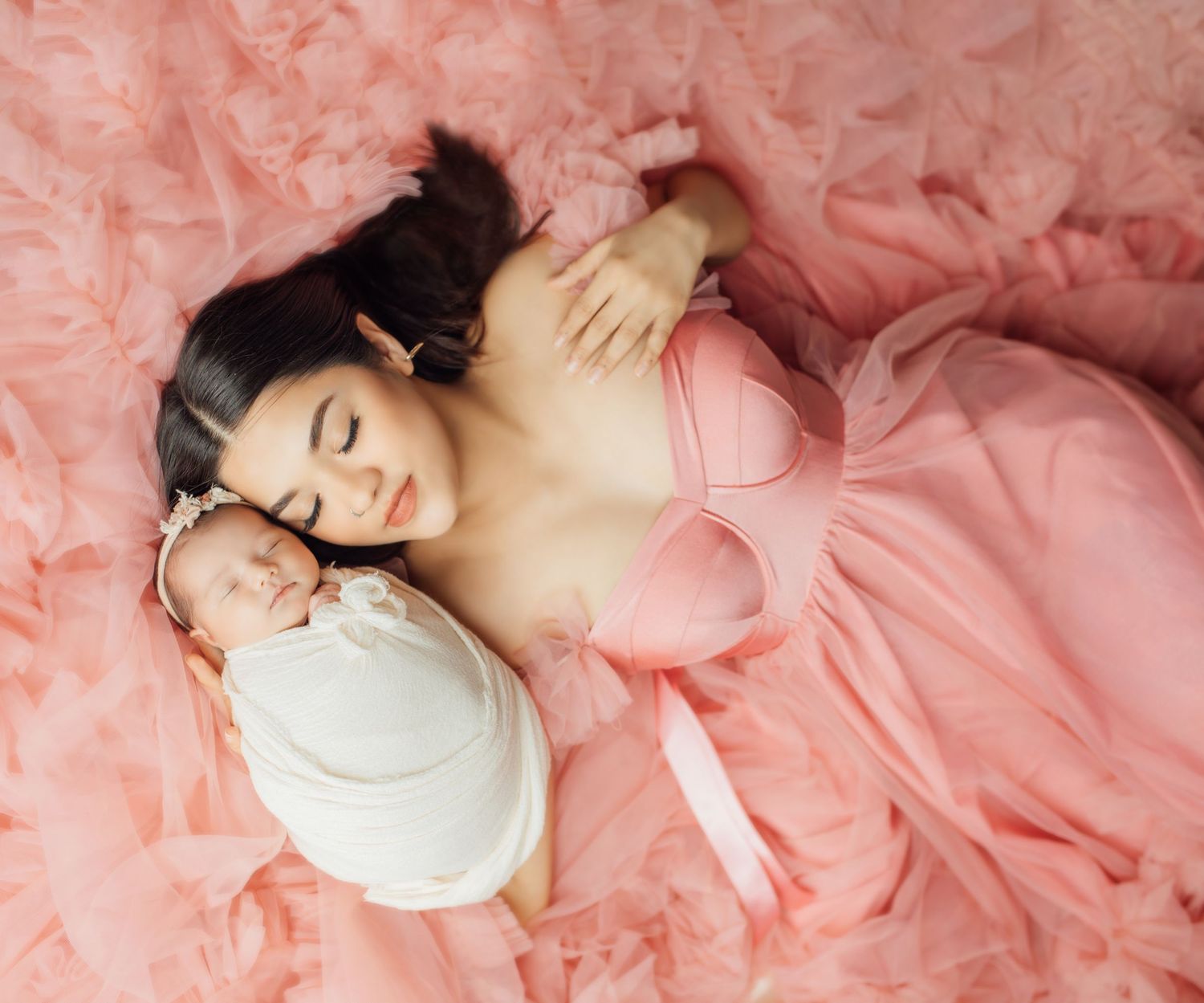 Newborn baby sleeping peacefully with mom in Oklahoma